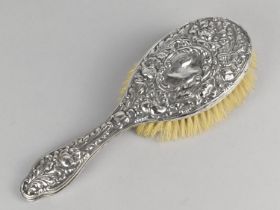 A Silver Mounted Dressing Table Brush with Floral Scrolled Repousse Decoration by S.D & S Ltd,