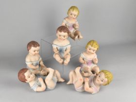 Six Continental Bisque Porcelain Piano Babies, 17cm high