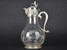 A Glass and Silver Plate Claret Jug, the Mount with Mask Head Lip, Floral Relief Decoration and