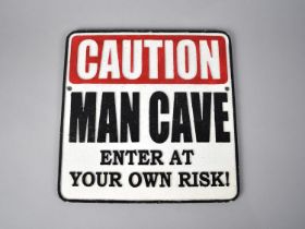 A Reproduction Cold Painted Cast Metal Sign, "Caution Man Cave", 24cms Square, plus VAT