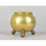 A Brass Pot in the Form of a Three Legged Cauldron, 7cms High