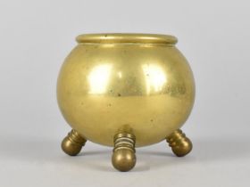 A Brass Pot in the Form of a Three Legged Cauldron, 7cms High