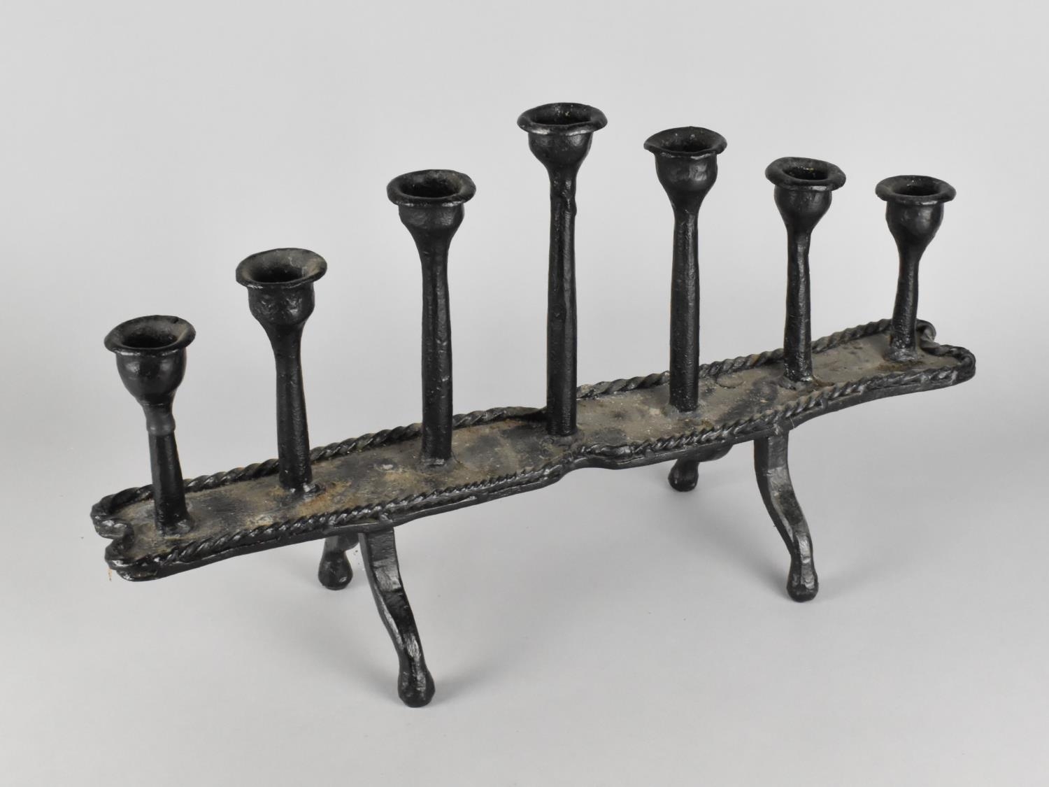 A Modern Heavy Cast Iron Seven Branch Candle Stand, 51cms Wide