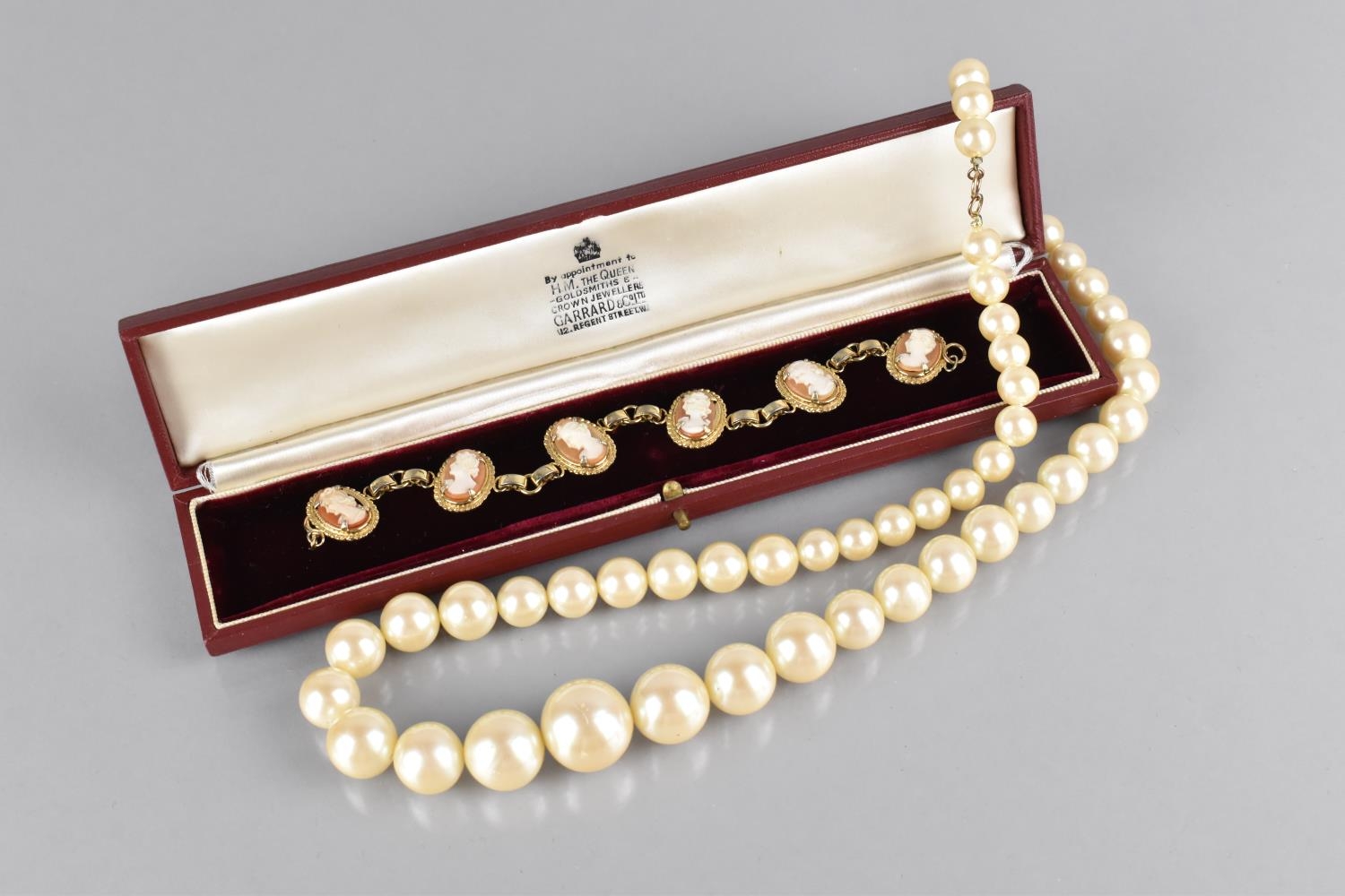 A Vintage Gold Plated Panelled Cameo Bracelet and a Faux Pearl Necklace with Gold Plated Clasp in