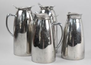 A Set of Four Elia Stainless Steel Lidded Jugs, the Tallest 21cm high