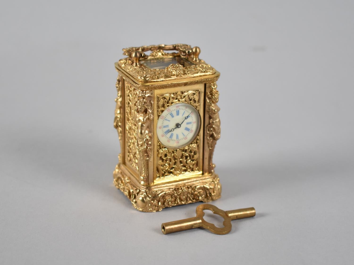 A Reproduction Ornate Gilt Brass Miniature Carriage Clock with White Enamelled Dial, Complete with