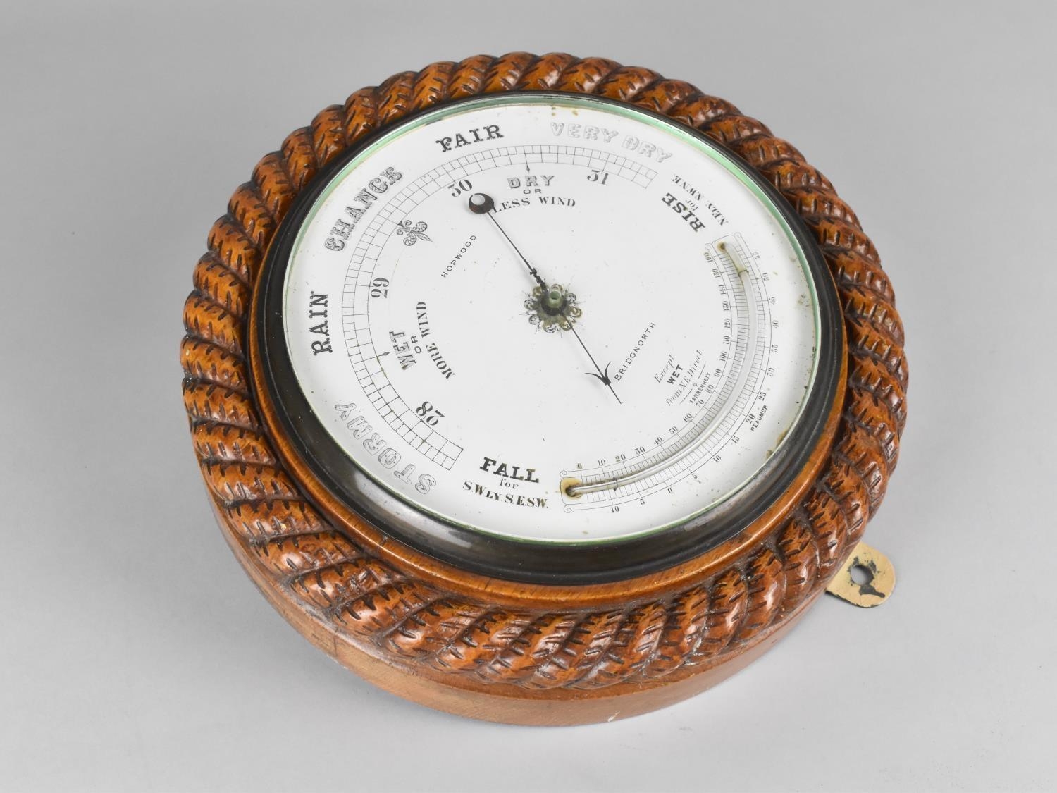 An Edwardian Circular Wall Hanging Aneroid Barometer with Carved Oak Rope Border, White Enamelled