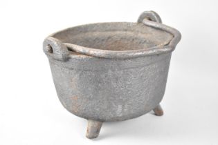 A Vintage Heavy Cast Iron Cooking Pot on Three Feet, 25cms Diameter