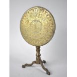 A Georgian Brass Candle Reflector in the Form of a Snap Top Tripod Table, Engraved Disc Depicting