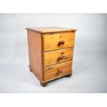 A Modern Pine Three Drawer Bedside Chest, 45cms Wide and 60cms High