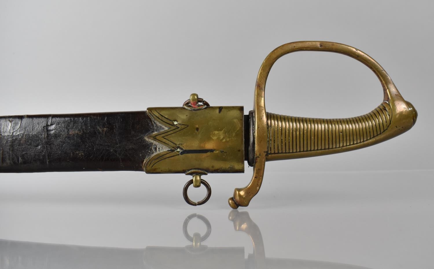 A French 1819 Pattern Briquet Short Sword having Ribbed Brass Grip and Slightly Curved Blade.