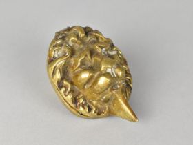 A Brass Lion Mask Door Knocker, 9cms High