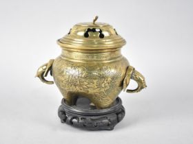 A Chinese Bronze Globular Lidded Censer with Elephant Head Handles and Engraved Body on Unrelated