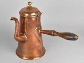 A Large Late 19th century Copper Side Pouring Coffee Pot with Turned Wooden Handle, 28cms High