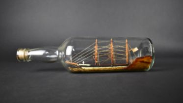 An Early 20th Century Folk Art Ship in a Bottle, 19cms Long