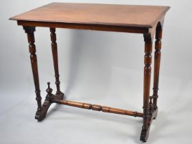 An Edwardian Mahogany Rectangular Occasional Table with turned Supports and Stretcher, 73cms by