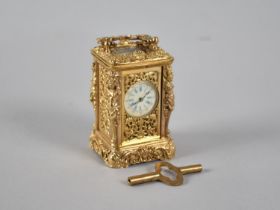 A Reproduction Ornate Gilt Brass Miniature Carriage Clock with White Enamelled Dial, Complete with