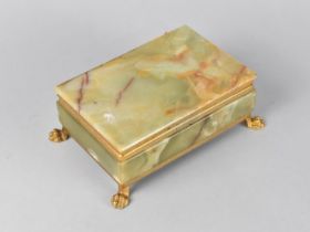 A Mid 20th Century Gilt Brass and Onyx Cigarette Box with Hinged Lid and Four Claw Feet, 17cm Wide