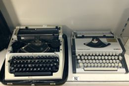 TWO VINTAGE CASED TYPEWRITERS, OLYMPIA TRAVELLER DELUXE S AND ANOTHER; EACH IN TRAVELLING CASE