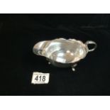 HALLMARKED SILVER OVAL SAUCEBOAT WITH SCROLL HANDLE ON PAD FEET DATED 1932 BY BLACKMORE & FLETCHER