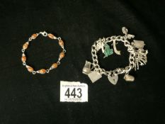 HALLMARKED SILVER WITH CHARMS WITH A HALLMARKED SILVER AND AMBER BRACELET