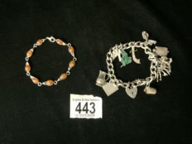 HALLMARKED SILVER WITH CHARMS WITH A HALLMARKED SILVER AND AMBER BRACELET
