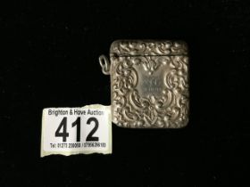 A VICTORIAN STERLING SILVER VESTA CASE; BIRMINGHAM 1898, EMBOSSED WITH SCROLL DECORATION;