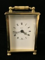 A BRASS CARRIAGE CLOCK; DIAL MARKED DOMINION; ROMAN NUMERALS; INTERIOR BACK INCUSE STAMPED 'I.FELD';