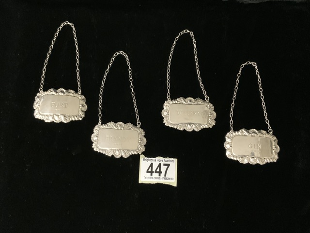 A SET OF FOUR STERLING SILVER WINE / SPIRIT LABELS; LONDON 1973-1975; RECTANGULAR FORM WITH SHELL;