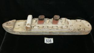 A VINTAGE WOODEN SCRATCH-BUILT MODEL OF A LINER, CIRCA 1930, ON THREE WHEELS LENGTH 45 CM, WIDTH 9