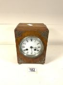 VINTAGE WOODEN CASED CLOCK ON BRASS BUN FEET WITH METAL FILAGREE MOUNTS TO THE FRONT (MISSING