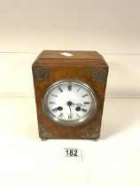 VINTAGE WOODEN CASED CLOCK ON BRASS BUN FEET WITH METAL FILAGREE MOUNTS TO THE FRONT (MISSING