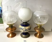 THREE VINTAGE OIL LAMPS; TWO COPPER AND ONE CERAMIC