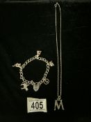A SILVER CHARM BRACELET & A SILVER INITIAL M PENDANT ON CHAIN; BRACELET WITH VARIOUS CHARMS
