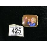 A CASED ANTIQUE CERAMIC PORTRAIT BROOCH; RECTANGULAR FORM; DEPICTING A SMALL BOY AND A PARROT;