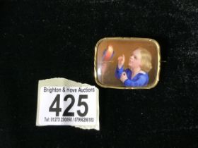 A CASED ANTIQUE CERAMIC PORTRAIT BROOCH; RECTANGULAR FORM; DEPICTING A SMALL BOY AND A PARROT;