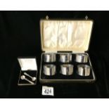 A CASED SET OF SIX STERLING SILVER NAPKIN RINGS BY F.H. ADAMS & CO; BIRMINGHAM 1928; PLAIN FORM;