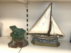 TWO VINTAGE CAST IRON DOOR STOPS, SAILING BOAT AND FROG; LARGEST 37 X 34CM