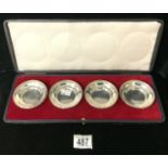 A BOXED SET OF FOUR STERLING SILVER CIRCULAR DISHES BY S. GARRARD; LONDON 1922; ONE ALSO STAMPED