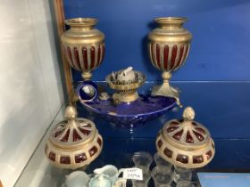 TWO BRASS AND CRANBERRY CONTAINERS WITH A CERAMIC OIL LAMP LARGEST; 40CM