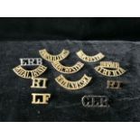 A QUANTITY OF MILITARY METAL SHOULDER TITLES; INCLUDING ROYAL IRISH, INNISKILLING, MANCHESTER AND
