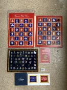 A FRAMED COLLECTION OF METAL AND ENAMEL BADGES, INCLUDING MILITARY, A VINTAGE FOLDER OF THE GREAT
