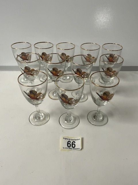 TWELVE VINTAGE SHERRY GLASSES; GILDED AND DECORATED WITH PHEASANTS IN FLIGHT