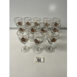 TWELVE VINTAGE SHERRY GLASSES; GILDED AND DECORATED WITH PHEASANTS IN FLIGHT