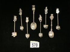 A SET OF SIX WHITE METAL COFFEE SPOONS, TERMINALS SHAPED AS MYTHICAL CREATURES, TWISTED STEMS AND