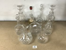 FOUR GLASS DECANTERS, THREE CARAFES WITH A MUSICAL BOLS DECANTER