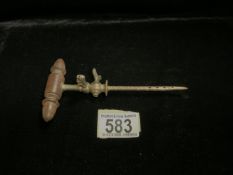 A 19TH CENTURY CHAMPAGNE TAP / CORKSCREW, SHAPED WOODEN HANDLE, SPOUT MODELLED AS A DOGS HEAD,