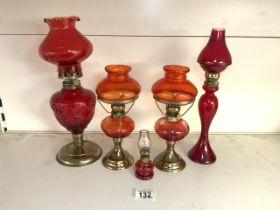 QUANTITY OF RED COLOURED GLASS OIL LAMPS