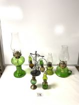 MIXED (MAINLY GREEN GLASS) OIL LAMPS; LARGEST 36CM