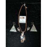SWAROVSKI; A SILVER AND COLOURED GLASS NECKLACE AND EARRING SET; MODERNIST FORM; THE NECKLACE ON A